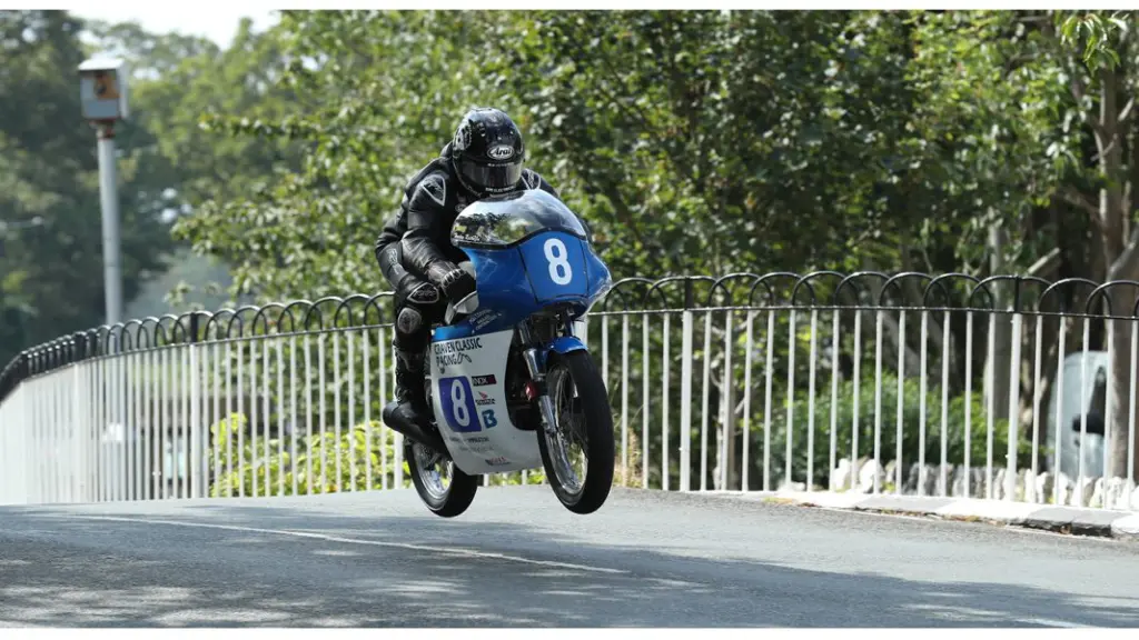 Manx Grand Prix : moto classique en vol sur un pont du circuit, ile de Man